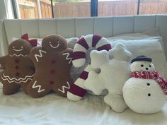 several stuffed animals are lined up on a bed