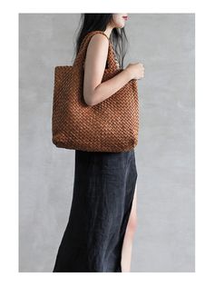 a woman carrying a brown woven tote bag