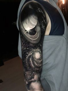 a man's arm with a space tattoo on it