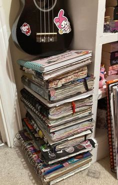 a guitar sitting on top of a stack of records