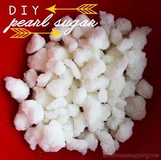 sugar cubes are sitting on top of a red surface with the words diy pearl sugar written above them