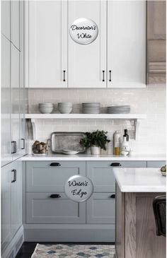 a kitchen with white cabinets and gray counter tops