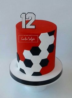 a red and black soccer themed cake with the number 12 on it's side