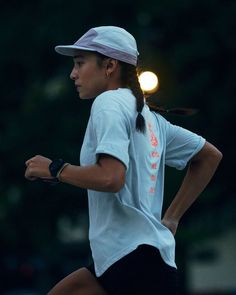 a female tennis player is running with her racket in her hand while wearing a white shirt and black shorts