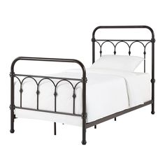 an iron bed frame with white sheets and pillows on it, against a white background