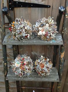 three wooden shelves filled with lots of different types of jewelry on top of each other