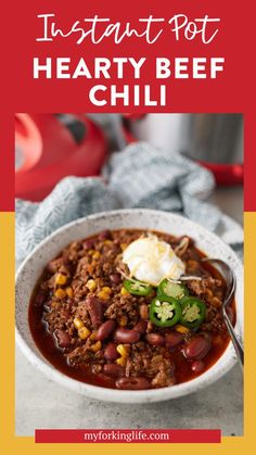 instant pot hearty beef chili in a white bowl with a spoon on the side