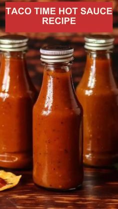 three small bottles filled with taco time hot sauce on top of a wooden table