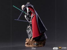 a star wars action figure is posed on top of a rock with two swords in his hand