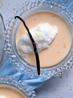 two desserts with whipped cream and chocolate are on the table next to each other