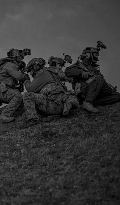 a group of soldiers kneeling down on top of a hill