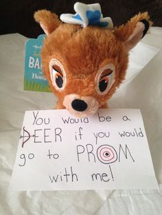 a stuffed animal holding a sign that says you would be a deer if you would go to prom with me