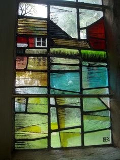 a stained glass window with a house on it