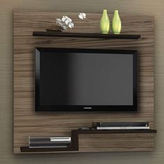 a flat screen tv mounted to the side of a wooden wall