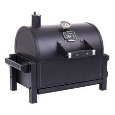 an outdoor charcoal grill with the lid open