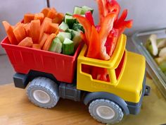 a toy truck filled with cut up vegetables