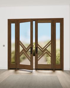 an open wooden door with glass panels on the inside and outside doors, in front of a white wall