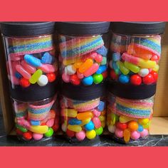 four glass jars filled with candy and candies