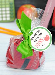 a bag filled with lots of red and green items on top of a white table