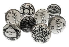 six different types of buttons with black and white designs on them, all in various sizes