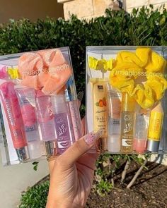 two clear boxes filled with different types of beauty products in front of some shrubbery