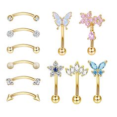 six different types of piercings with butterfly, flower and crystal stones on each one