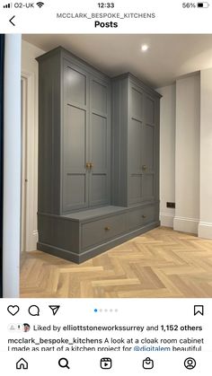 an empty room with gray cabinets and wood flooring on the bottom right hand corner