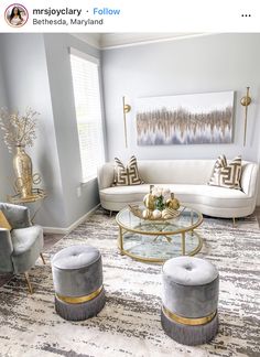 a living room with couches, chairs and a coffee table in front of a window