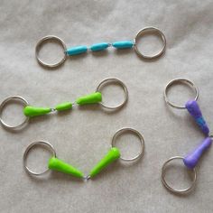 four pairs of scissors with green and blue handles