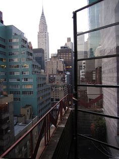 the city skyline is seen from an apartment balcony