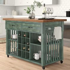 a kitchen island with wine glasses on it