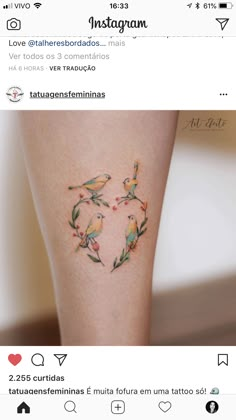 the back of a woman's leg with birds on it and leaves in the shape of a heart