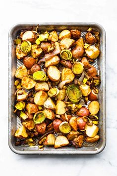 roasted brussel sprouts in a baking pan on a marble countertop