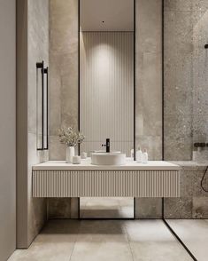 a modern bathroom with two sinks and mirrors