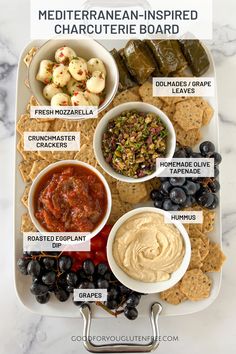 the mediterranean inspired charcute board is full of different types of dips, crackers and olives