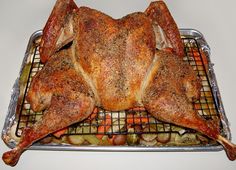 a whole chicken sitting on top of a metal rack