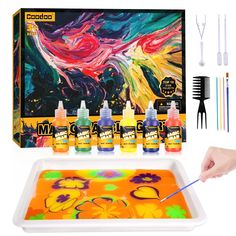 the kit includes paint, brushes and glues to create an abstract painting with acrylic colors