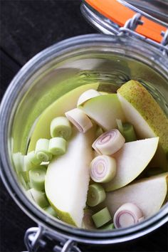 sliced apples and onions in a glass jar