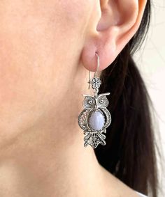 Introducing these exquisite Blue Lace Agate gemstone dangle drop earrings featuring a beautifully crafted 925 sterling silver filigree owl design. Handmade by our master artisan, these earrings are the perfect blend of traditional and modern art, featuring intricate filigree details that are both elegant and timeless. The multi-layers of 925 sterling silver oxidized finishes set on the blue stone, are enhanced by the stunning center-cut Blue Lace Agate gemstone of 8x10 mm, cabochon oval-cut. Whe Handmade Chalcedony Earrings For Gifts, Handmade Chalcedony Earrings As Gift, Elegant Chalcedony Drop Earrings, Elegant Handmade Chalcedony Earrings, Elegant Nickel-free Chalcedony Jewelry, Owl Earrings, Art Women, Owl Design, Sterling Silver Filigree