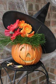 a pumpkin with a witches hat on top of it