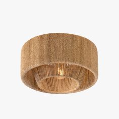 the light fixture is made out of woven material and has a round shade on top