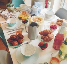 a white table topped with lots of food and drinks