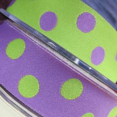 purple and green polka dot ribbon on white background