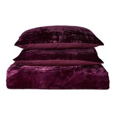 three velvet pillows stacked on top of each other