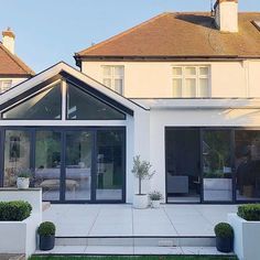 a large white house with glass doors and windows