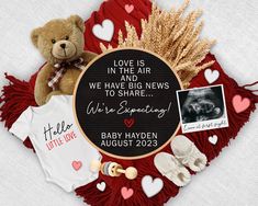 a teddy bear and other items are arranged around a sign that reads love is in the air we have news to share we're expecting