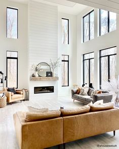 a living room filled with furniture and lots of windows