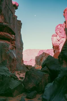 the sun is shining on some rocks and boulders