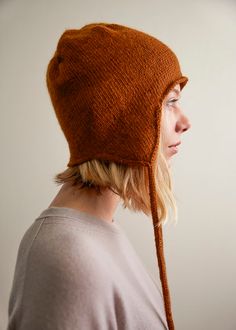 a woman wearing a brown knitted hat