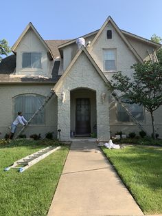 a man painting the outside of a house